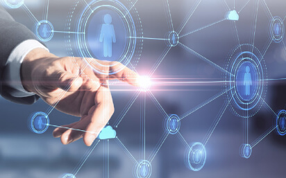 Hand with pointing finger lighting up while touching a screen of avatars in a circle connected